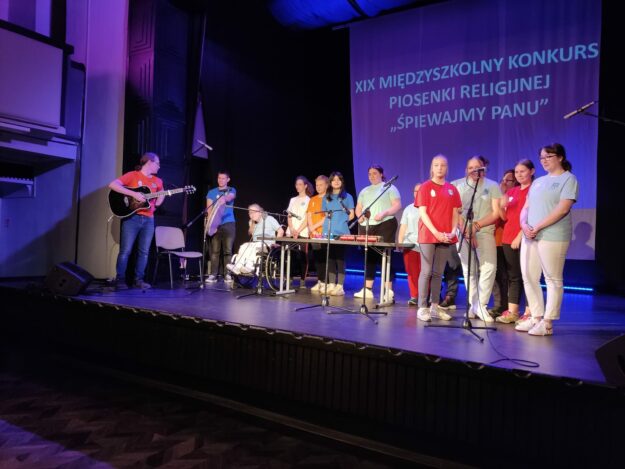 członkowie zespołu stoją na scenie