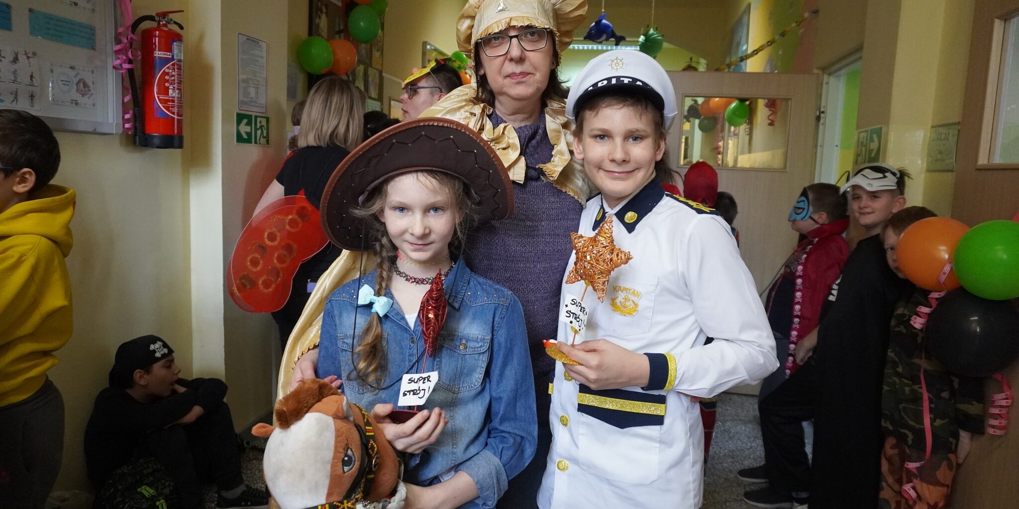 uczniowie w strojach karnawałowych na korytarzu szkolnym